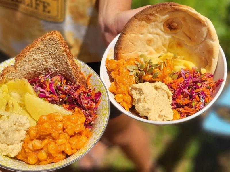 Bright camp bowls with chickpeas, salad, bread, and sauce